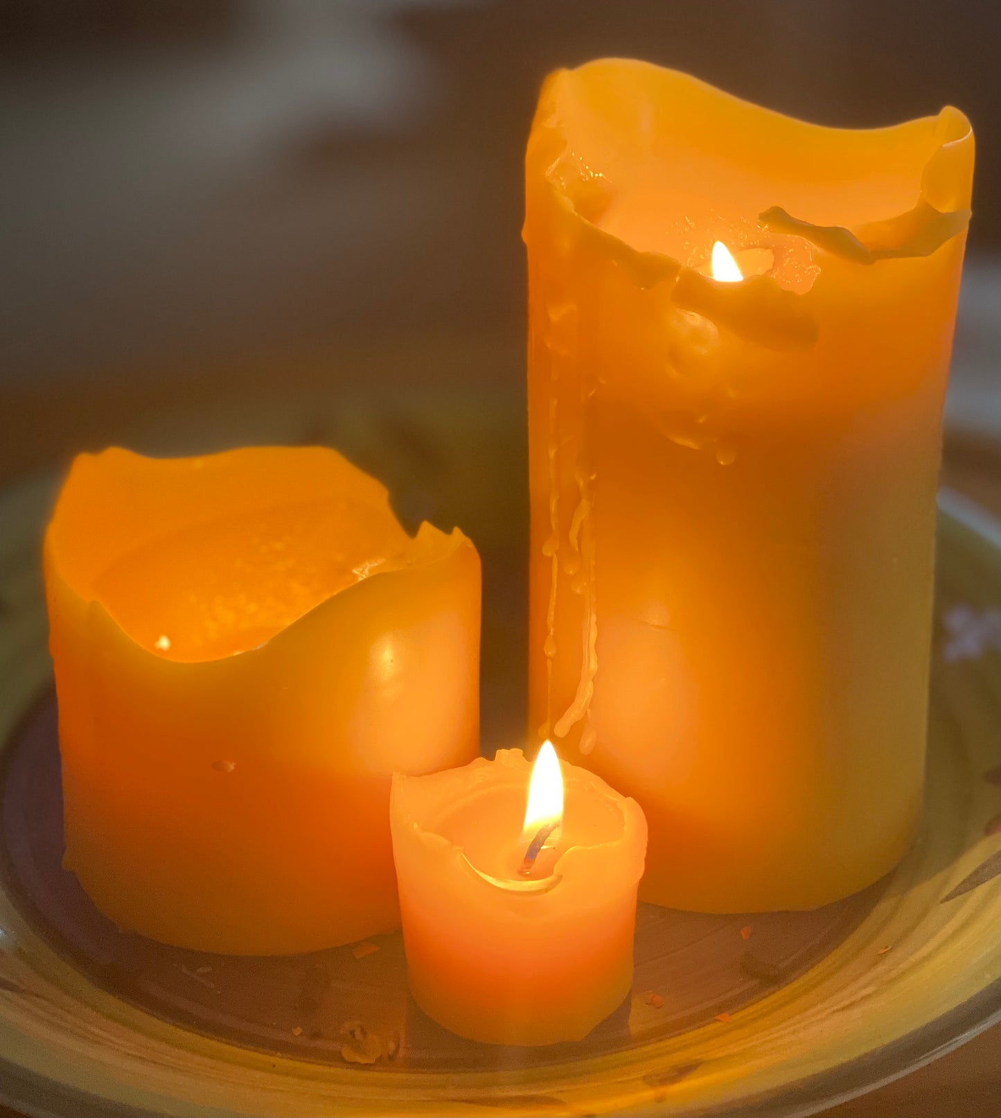 Picture of beeswax pillar candles alight. picture shows how they can look when burning and alight from within